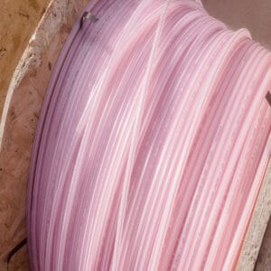 High-density polyethylene tubes, 12mm diameter, in large coils, are ready to be interred, as a protection for communication cables. The name printed as a manufacturer is SAMIPLASTIC S.p.A.
