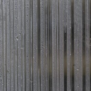 Close-up of a polycarbonate greenhouse wall. Porous polycarbonate sheet with condensation drops inside.